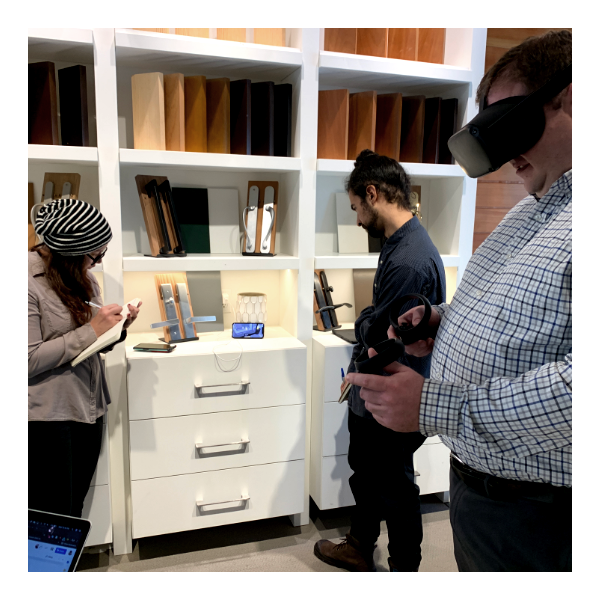 Colleagues observe the live feed of an architect interacting in the VR experience