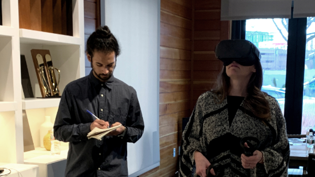 Test participant wears a headset while I stand by taking notes.