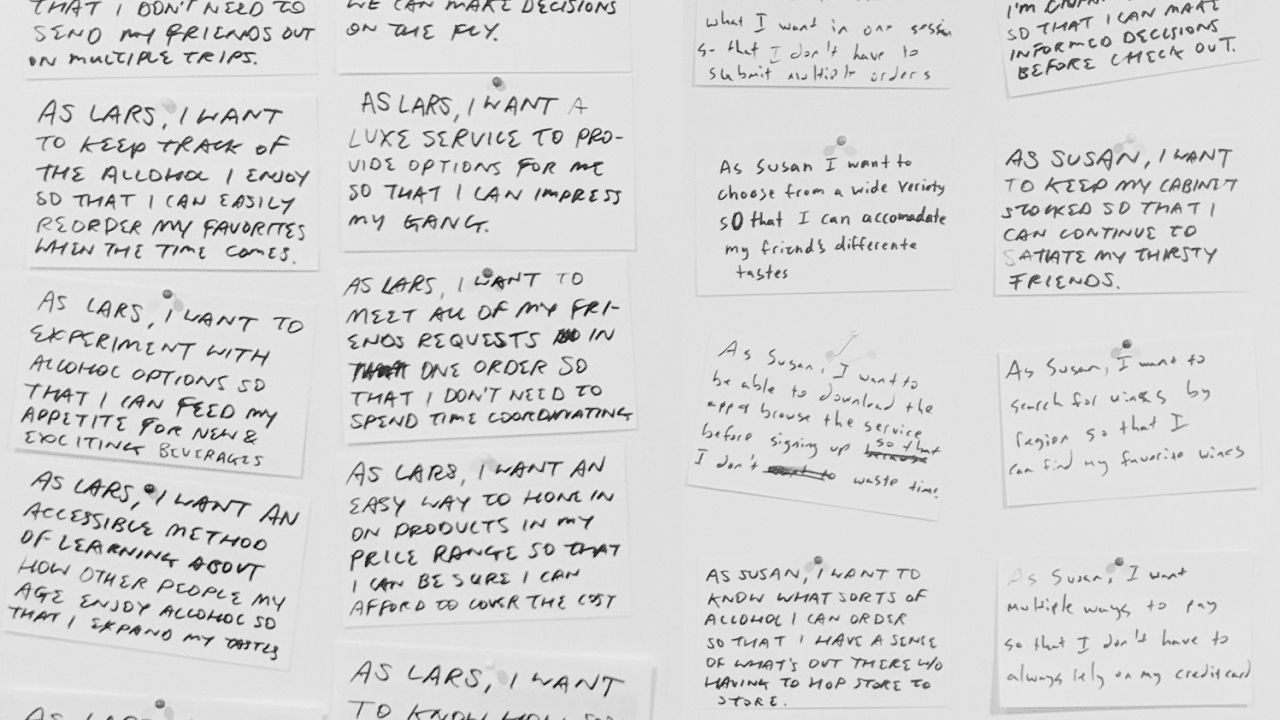 User stories written on index cards are pinned to a foamcore board.